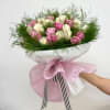 Bouquet of pink and white roses wrapped in pink paper