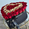 Heart-shaped box of red and gold roses with a black ribbon