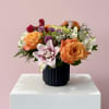 A bold mix of vibrant pinks, juicy oranges, and fresh light greens