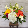 A vibrant blend of golden yellow and coral roses, creamy calla lilies