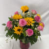 Select this beautiful and bright arrangement featuring pink roses, sun flowers, and
