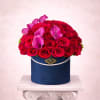 Red rose arrangement with pink calla lilies in a blue hatbox