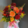 This beautiful flower arrangement of fresh mixed seasonal blooms is made by
