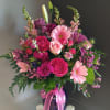 This beautiful flower arrangement of fresh mixed seasonal blooms is made by