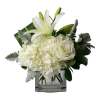 White lilies and roses arranged in a square glass vase