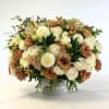 Cream and tan rose bouquet in a white vase
