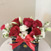 This luxurious arrangement features premium red roses and elegant white blooms beautifully