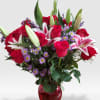 A beautiful vase arrangement in a red or clear vase 24 Rose's