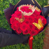 Bouquet of red roses with a gold crown and butterflies in black wrapping