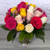 Mixed roses in a clear glass vase with small purple filler flowers