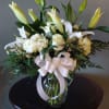 This beautiful all white arrangement exudes simple elegance. It is a perfect
