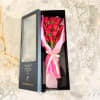 Boxed bouquet of red roses wrapped in pink tissue