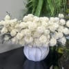 A stunning arrangement of elegant white blooms designed in a modern asymmetric