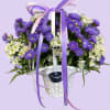 Purple and white daisy bouquet in a white basket with ribbon bows