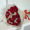 Bouquet of red roses with baby's breath in cream wrapping