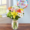 Mixed bouquet in a glass jar with a happy birthday balloon