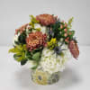 Warm rust-colored mums, creamy white hydrangea, soft yellow solidago, and playful accents