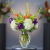 Brimming over the vase, these orange, violet and white blooms are easy