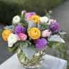 Our sweet spring design features fragrant hyacinth, stock, tulip, and ranunculus artfully