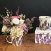 Soft colored seasonal florals come together in a beautifully illustrated lavender ceramic