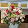 Silky-smooth cymbidium orchid mixed with roses, lisianthus and baby green hydrangea is