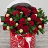 24 premium fresh roses accented with elegant greenery and paired with Ferrero