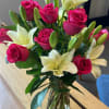 This arrangement consists of a dozen long-stemmed premium roses upgraded with white