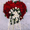 Heart-shaped red rose standing spray with white lilies and orchids