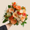 Warm, radiant, and beautifully romantic, the Golden Peach Garden bouquet celebrates soft