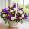 Elevate your gifting experience with our exquisite purple posies basket arrangement, bursting