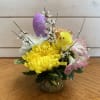 A little yellow chick and sparkly egg nest in this petite arrangement
