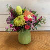 A bright easter arrangement with a little chick and sparkly egg amongst