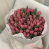 Bouquet of pink tulips wrapped in white paper