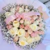 Bouquet of cream and blush roses with a pink ribbon