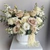 This soft and elegant arrangement features blush pink roses, creamy white blooms