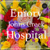 Colorful mixed bouquet with roses, irises, and yellow blooms behind hospital text overlay