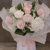 light pink roses, peonies and hydrangeas bouquet wrapped in soft color papers
