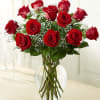 Red roses arranged in a clear glass vase