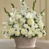 White floral arrangement in a woven basket