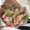 A soft, timeless mix of blush, tan, cream, and peach-toned roses, accented