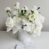 Seattle's Signature Centerpiece of pure white blooms set in an elegant container
