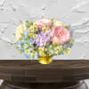 Pastel bouquet of roses, hydrangeas, and daisies in a gold vase