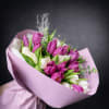 Bouquet of pink and white tulips wrapped in lavender paper