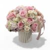 Pink and white rose bouquet in a ribbed cream vase