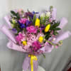 A stunning hand-tied bouquet featuring hydrangeas, tulips, carnations, seasonal blooms, and fresh