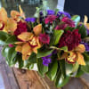 Tropical bouquet with orange orchids and magenta flowers