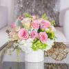 A short and sweet arrangement of pink Roses and pink Ranunculus with