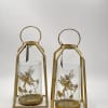 These charming lanterns feature a golden metal frame with delicate dragonfly and