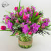 Happiness
Bright, energetic blooms arranged in a clear glass vase wrapped in rustic
