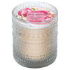 Scented candle in a textured glass holder with a floral lid label